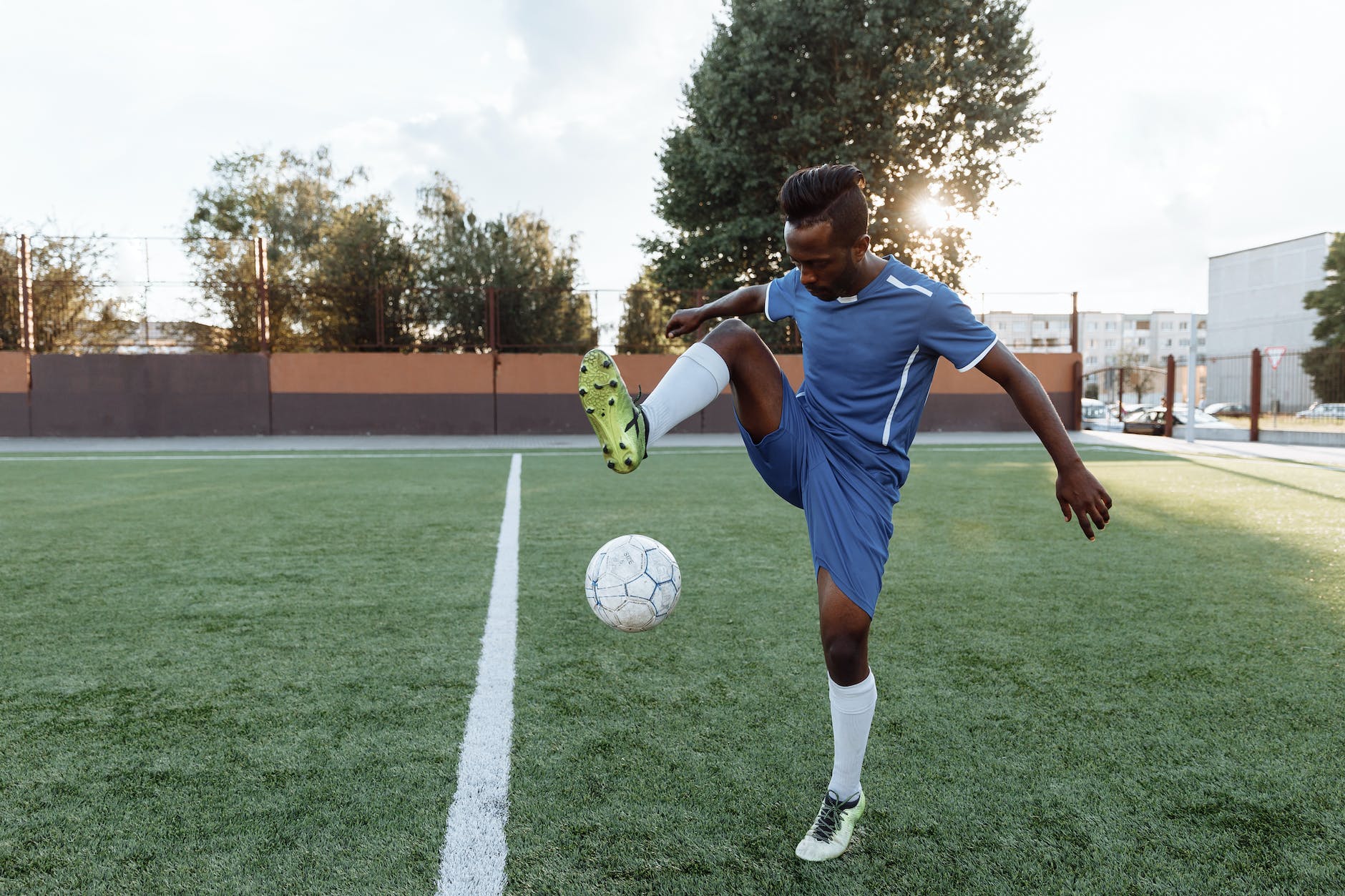 a man doing football tricks on the field