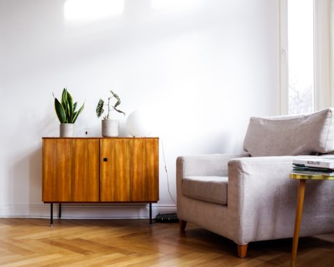 brown wooden table beside gray couch