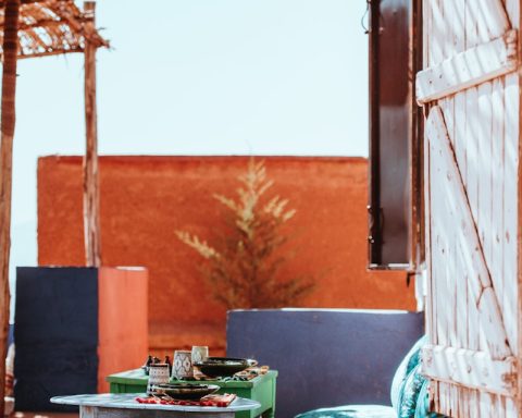 table beside green floral sofa