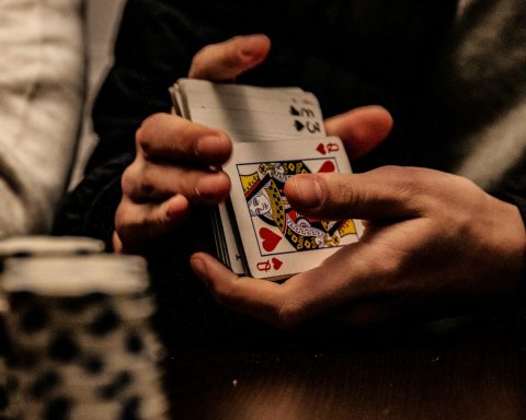 person holding king of spade playing card