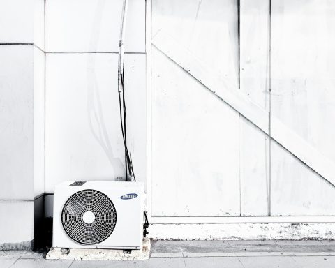 grayscale photography of outdoor AC unit
