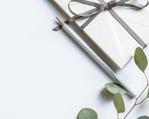flat lay photo of book and pencil