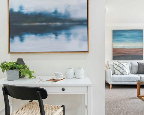 white and black table with chairs near body of water painting