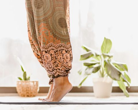 person in brown and beige floral skirt standing on white table