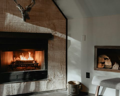 a living room with a fire place and a chair