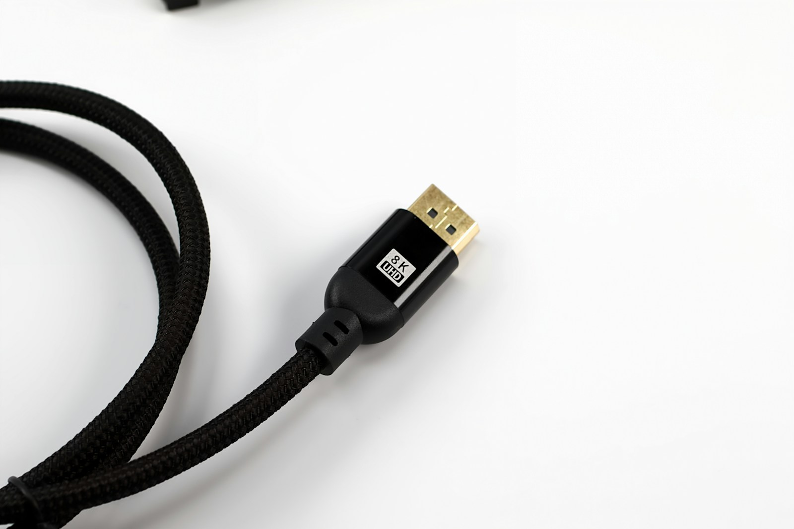 A black braided cable with a gold connector.
